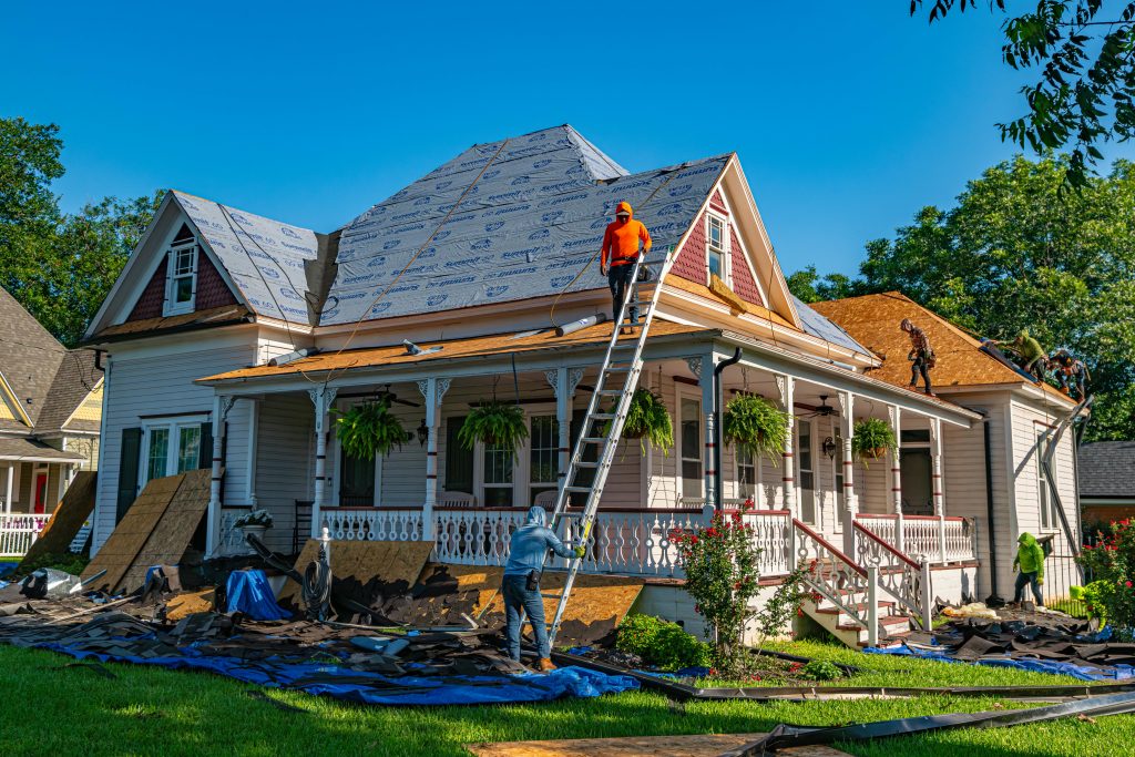 men replacing a roof