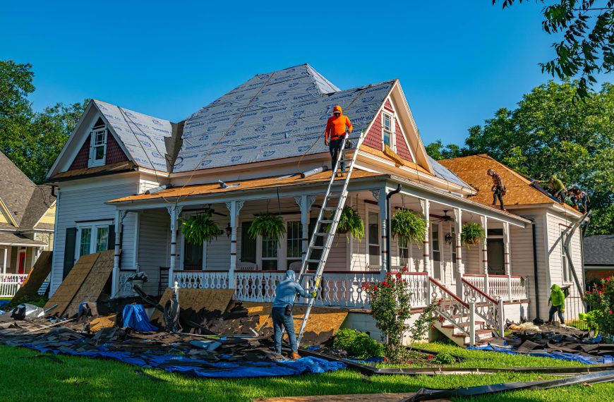 men replacing a roof